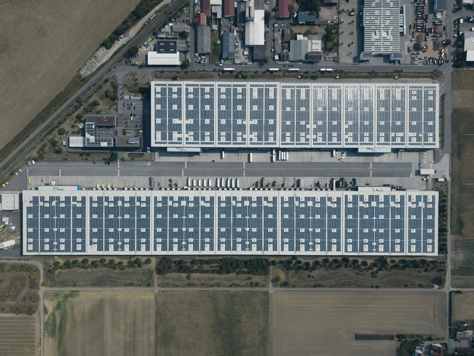 Vista aérea de um centro de distribuição com docas e carretas